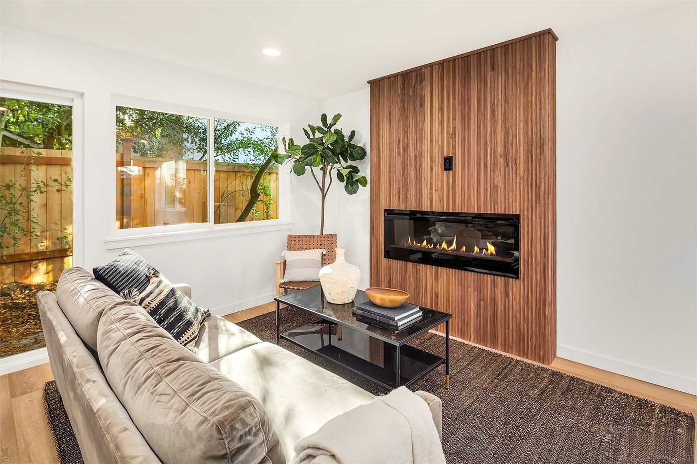 Living room with a fireplace wall and a wood accent panel