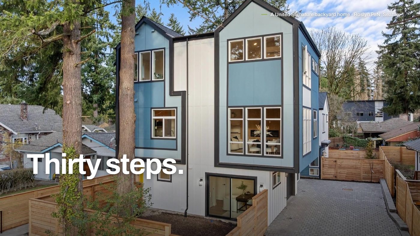 Thirty steps. A two-story United Signature backyard home on Roslyn Pl N, Seattle, behind a cedar fence